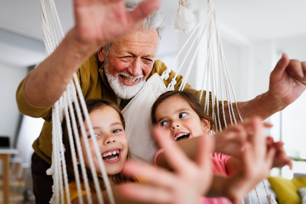 grandfather playing with his granddaughters